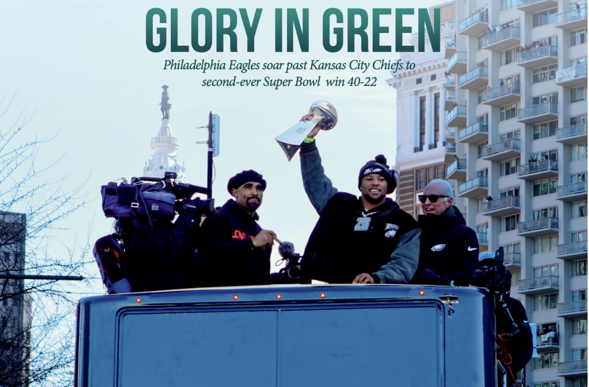 “E-A-G-L-E-S! Eagles!”: Philadelphia Eagles running back Saquon Barkley, alongside Eagles quarterback Jalen Hurts and owner Jeffrey Lurie, holds up the Vince Lombardi Trophy during the Feb. 14 victory parade. The team’s win on Feb. 9 marked Barkley and Hurts’ first Super Bowl victory.